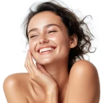 Woman smiling while touching her flawless glowy smooth skin